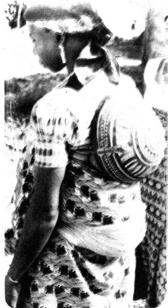 Calabash shields baby head. Pabir woman